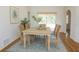 Bright dining room features woven chairs, a modern rug and sliding glass doors to the exterior at 29211 Picador St, Punta Gorda, FL 33982