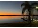 Picturesque twilight view of lake and dock from a peaceful backyard in a prime piece of real estate at 29211 Picador St, Punta Gorda, FL 33982