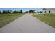 Long driveway leading to property, providing ample parking and access to surrounding buildings at 29211 Picador St, Punta Gorda, FL 33982
