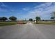 Community entrance featuring well-maintained landscaping, signage and a security gate at 29211 Picador St, Punta Gorda, FL 33982