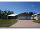 Charming single-story home with a metal roof, three-car garage, and a spacious driveway, offering modern convenience and curb appeal at 29211 Picador St, Punta Gorda, FL 33982