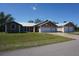 Charming single-story home featuring a metal roof and three-car garage in a well-manicured yard at 29211 Picador St, Punta Gorda, FL 33982
