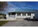 Ranch style house with a blue metal roof and white picket fence with a ramp at 29211 Picador St, Punta Gorda, FL 33982