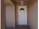 Inviting front door with a decorative window and sidelight, sheltered by a covered porch at 29211 Picador St, Punta Gorda, FL 33982