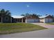 Charming single-story home with a three-car garage, manicured lawn, and mature landscaping at 29211 Picador St, Punta Gorda, FL 33982