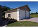 Detached two-car garage with white doors and framed by a well manicured green lawn at 29211 Picador St, Punta Gorda, FL 33982