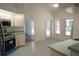 Bright kitchen area with tiled floors, white cabinets, and access to the backyard at 29211 Picador St, Punta Gorda, FL 33982