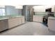 Open kitchen design featuring stainless steel appliances, white cabinetry, and a long countertop with a sink at 29211 Picador St, Punta Gorda, FL 33982