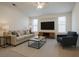 Cozy living room featuring neutral-toned furniture, modern decor, and ample natural light at 29211 Picador St, Punta Gorda, FL 33982