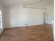 Spacious living room with wood floors, white walls, and natural light from arched windows at 29211 Picador St, Punta Gorda, FL 33982