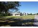 Property and home exterior with manicured lawn and mature trees, creating an inviting and well-maintained setting at 29211 Picador St, Punta Gorda, FL 33982
