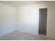 Empty room with white walls, unfinished floors, a visible power outlet, and a doorway at 29211 Picador St, Punta Gorda, FL 33982