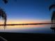Beautiful evening sunset view over the water with palms silhouetted and calm, reflective waters at 29211 Picador St, Punta Gorda, FL 33982