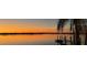 Stunning sunset view over the lake, accentuated by palm trees, creating a tropical ambiance at 29211 Picador St, Punta Gorda, FL 33982