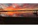Spectacular waterfront sunset reflecting vivid colors, featuring a dock and grasses for serene, picturesque living at 29211 Picador St, Punta Gorda, FL 33982