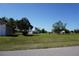 Spacious grassy lot with trees on a clear day, offering ample space for outdoor activities at 29211 Picador St, Punta Gorda, FL 33982