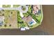 A high-angle shot showing a waterfront property with a screened pool and a boat dock on a sunny day at 3016 Curry Ter, Port Charlotte, FL 33981
