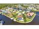 Waterfront homes on canals featuring boat docks and lush tropical landscaping in an aerial view at 3016 Curry Ter, Port Charlotte, FL 33981