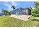 A backyard patio with bright blue Adirondack chairs overlooking the canal waters at 3016 Curry Ter, Port Charlotte, FL 33981