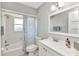 Clean and bright bathroom featuring a shower/tub, a window, and ample vanity space at 3016 Curry Ter, Port Charlotte, FL 33981