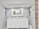 Modern bathroom features a double vanity, bright lights, and granite countertops at 3016 Curry Ter, Port Charlotte, FL 33981