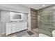 Modern bathroom features a double vanity, a stone-tiled shower, and ample storage at 3016 Curry Ter, Port Charlotte, FL 33981