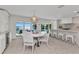 Eat-in dining area near kitchen features water views, modern lighting and white table and chairs at 3016 Curry Ter, Port Charlotte, FL 33981