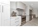 Bright kitchen featuring stainless steel appliances, marble backsplash, oven range and white cabinets at 3016 Curry Ter, Port Charlotte, FL 33981