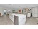Bright kitchen featuring marble island with farm sink, stainless steel appliances, and eat in dining area at 3016 Curry Ter, Port Charlotte, FL 33981