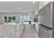 Open concept kitchen features a marble island with stainless steel appliances and water views at 3016 Curry Ter, Port Charlotte, FL 33981
