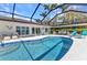 Screened-in pool area with an in-ground pool and various seating arrangements for entertaining at 3016 Curry Ter, Port Charlotte, FL 33981