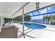 This screened patio features ample seating and a relaxing pool with a water view at 3016 Curry Ter, Port Charlotte, FL 33981