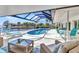 This beautiful screened patio features ample seating with a beautiful pool and water view at 3016 Curry Ter, Port Charlotte, FL 33981