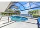 This screened patio features ample seating and a relaxing pool with a water view at 3016 Curry Ter, Port Charlotte, FL 33981