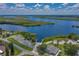 An aerial view of a boat ramp leading into a wide river surrounded by lush green vegetation at 3051 Chicory Ter, Punta Gorda, FL 33983