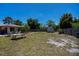 Backyard featuring a picnic table, lush lawn, and a storage shed at 3051 Chicory Ter, Punta Gorda, FL 33983