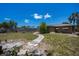 Spacious backyard featuring a winding stone path, fire pit, and a well-maintained lawn at 3051 Chicory Ter, Punta Gorda, FL 33983