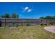 View of the fenced yard area with raised garden beds featuring green plants under a sunny sky at 3051 Chicory Ter, Punta Gorda, FL 33983