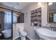 Modern bathroom with walk-in shower, white vanity, and decorative shelving for storage at 3051 Chicory Ter, Punta Gorda, FL 33983