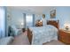 Charming bedroom with a light-blue color scheme, carpet, and natural-wood furniture in the English cottage style at 3051 Chicory Ter, Punta Gorda, FL 33983