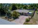 Charming single-story home with a brick-paved driveway and lush tropical landscaping, enclosed by a wooden fence at 3051 Chicory Ter, Punta Gorda, FL 33983