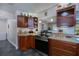Modern kitchen featuring tile floors, wood cabinets, and stainless steel appliances at 3051 Chicory Ter, Punta Gorda, FL 33983