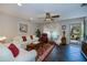 Bright living room with plush white sofas, a ceiling fan, and access to the outdoor patio at 3051 Chicory Ter, Punta Gorda, FL 33983