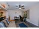 Bright office features a ceiling fan, desk, and a comfortable sitting area with a dark tile floor at 3051 Chicory Ter, Punta Gorda, FL 33983