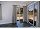 View through sliding glass doors to a brick patio and a fenced yard with mature trees and lawn at 3051 Chicory Ter, Punta Gorda, FL 33983
