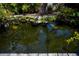 Natural pond with rock edging and lush greenery, creating a serene outdoor retreat at 3051 Chicory Ter, Punta Gorda, FL 33983