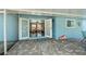 Covered back porch with nice stone floor and view to the interior of the home at 3175 Lakatos St, North Port, FL 34286
