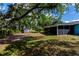 A view of the backyard showing the screened-in lanai and storage shed at 3175 Lakatos St, North Port, FL 34286