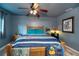 Comfortable bedroom featuring a wood frame bed, ceiling fan, and nautical decor at 3175 Lakatos St, North Port, FL 34286