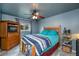 Comfortable bedroom with a wooden bed frame and a ceiling fan at 3175 Lakatos St, North Port, FL 34286